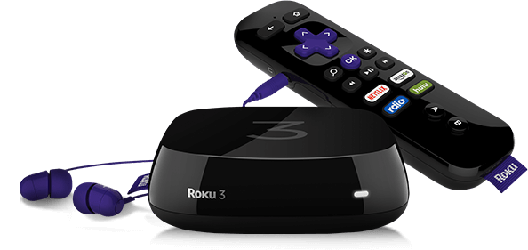 An Roku streaming device alongside its remote control and plugged in headphones.